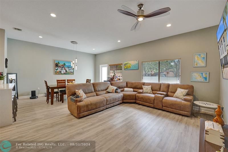 Entry with the garage access on the left and half bath on the right leading to the kitchen and living room.