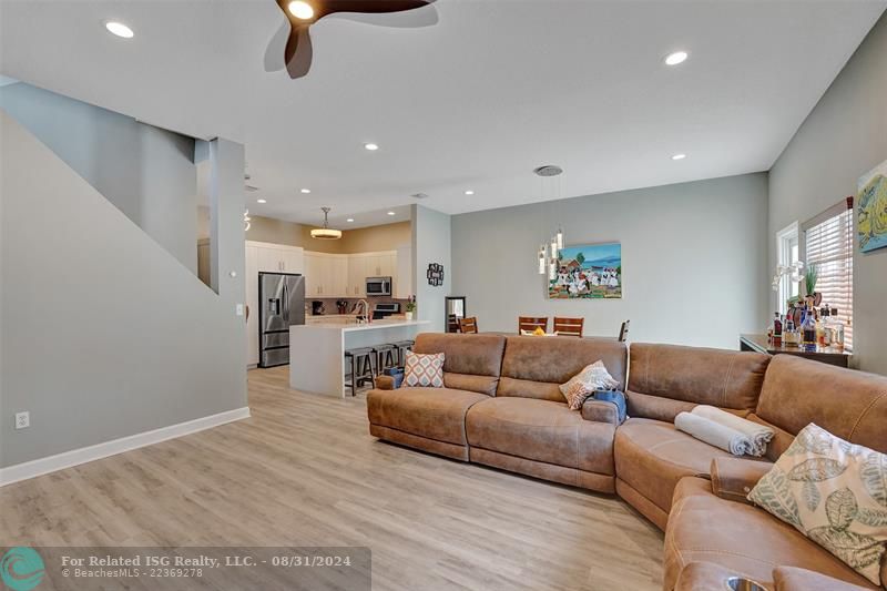 Entry with the garage access on the left and half bath on the right leading to the kitchen and living room.