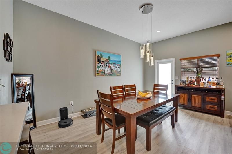 Entry with the garage access on the left and half bath on the right leading to the kitchen and living room.