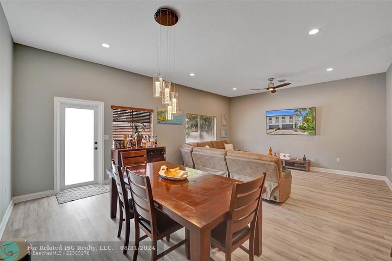 Entry with the garage access on the left and half bath on the right leading to the kitchen and living room.