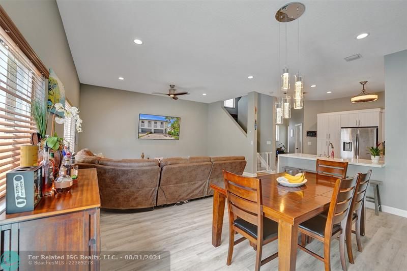 Entry with the garage access on the left and half bath on the right leading to the kitchen and living room.