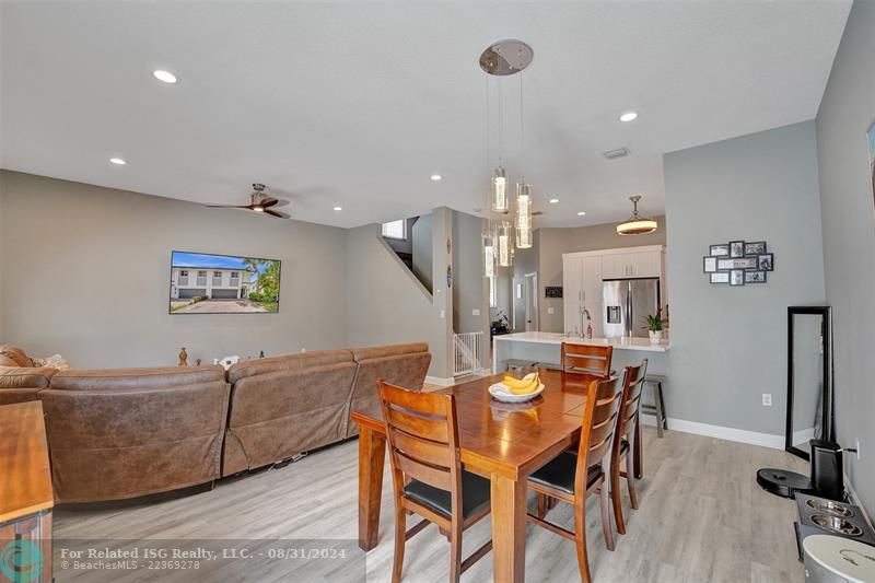 Entry with the garage access on the left and half bath on the right leading to the kitchen and living room.