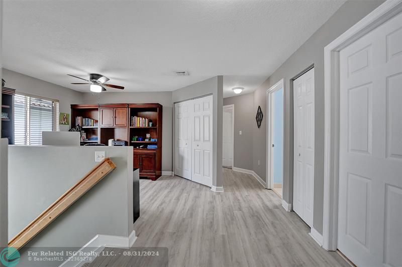 Entry with the garage access on the left and half bath on the right leading to the kitchen and living room.