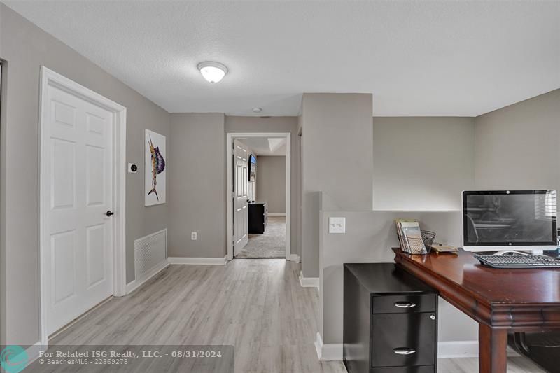 Entry with the garage access on the left and half bath on the right leading to the kitchen and living room.