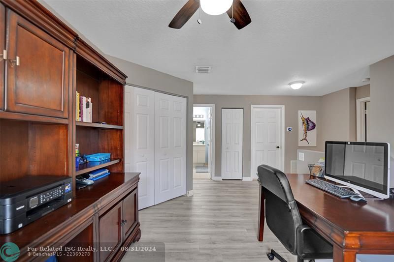 Entry with the garage access on the left and half bath on the right leading to the kitchen and living room.