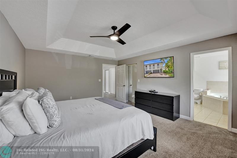 Entry with the garage access on the left and half bath on the right leading to the kitchen and living room.