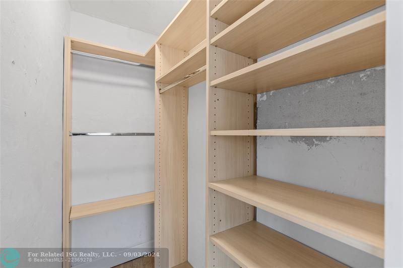 Walk-in closet of primary bedroom