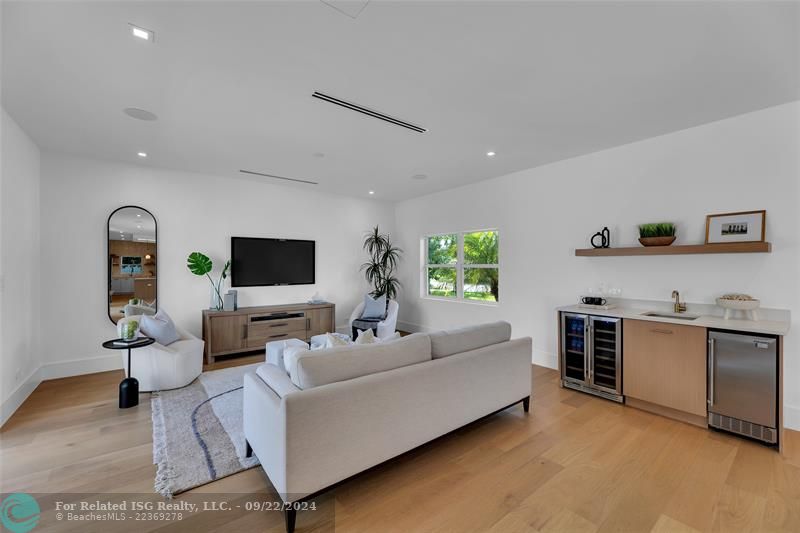 Living room with built in wet bar and wine cooler