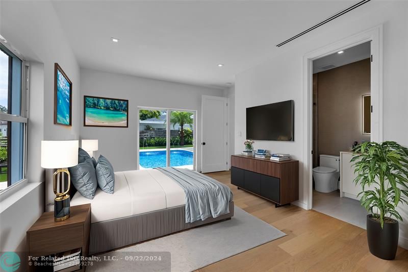 Bedroom 1 virtually staged with ensuite bathroom & pool view on the first floor