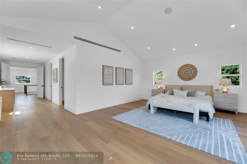 primary bedroom with sitting area and balcony with the canal views