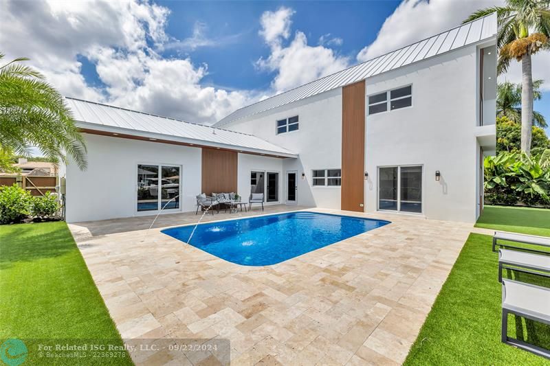 Backyard with low maintenance turf, pool and fountain