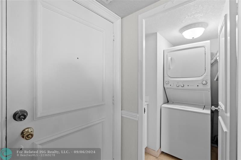 Separate laundry room with storage in condo