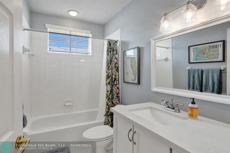 updated vanity with white cabinets & quartz countertop