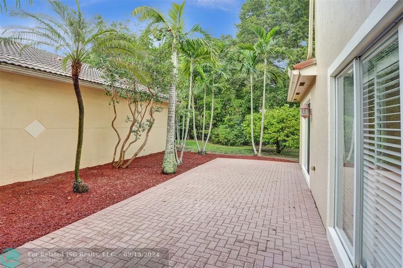 This large patio offers full privacy. To your right, you'll find the dining area and kitchen, with additional access to the patio through the sliding doors.