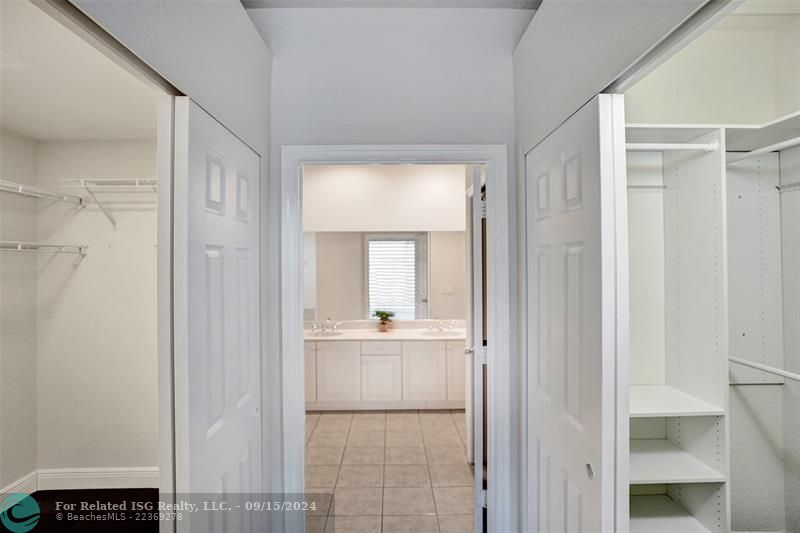 His and hers closets lead the way to the master bathroom.