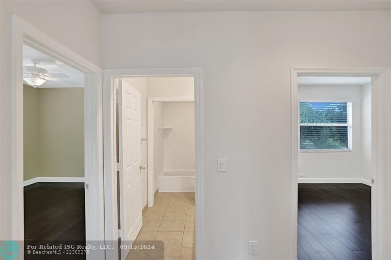 Bedroom #2 and #3 facing the backyard and separated by a full bathroom.