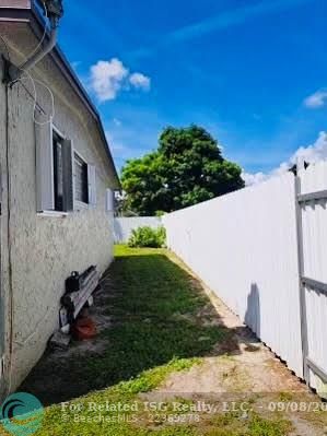 Main property side entrance with fence and gate for privacy