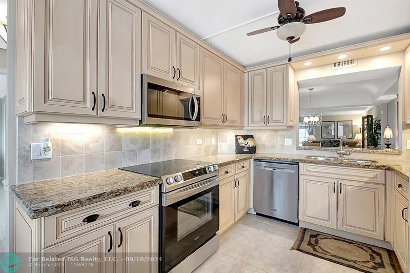 Gorgeously Updated Kitchen with All Wood cabinets, Granite Countertops & Tile Backsplash! Open to Dining Room, Living Room and Views!