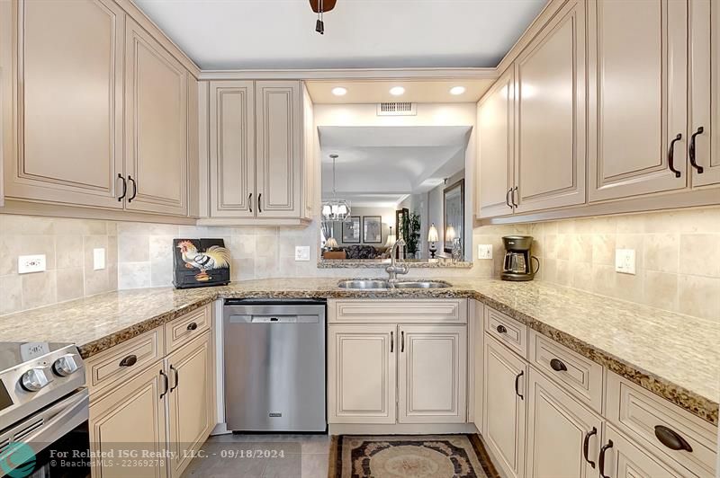 Gorgeously Updated Kitchen with All Wood cabinets, Granite Countertops & Tile Backsplash! Open to Dining Room, Living Room and Views!