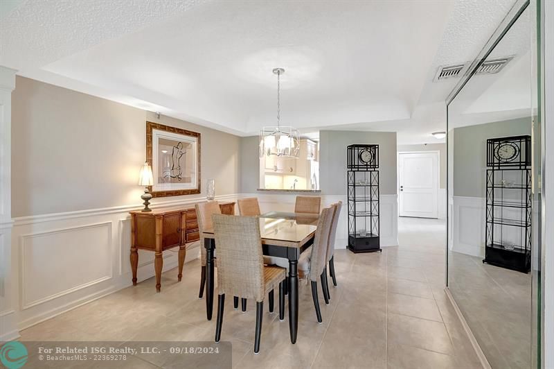 Formal Dining Area OpenTo Kitchen, with Wainscoting and Crown Mouldiing Throughout This Stunning Penthouse Corner Unit! 1906 Sq FT! 2 Master Bedrooms with En-Suite Bathroom and 1 Half Bath for Guest!