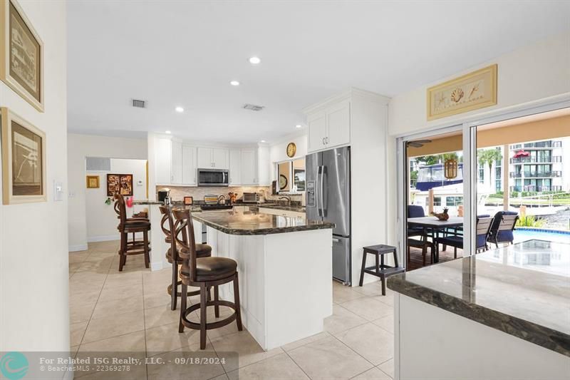 OPEN KITCHEN WITH SLIDING GLASS DOOR TO PATIO