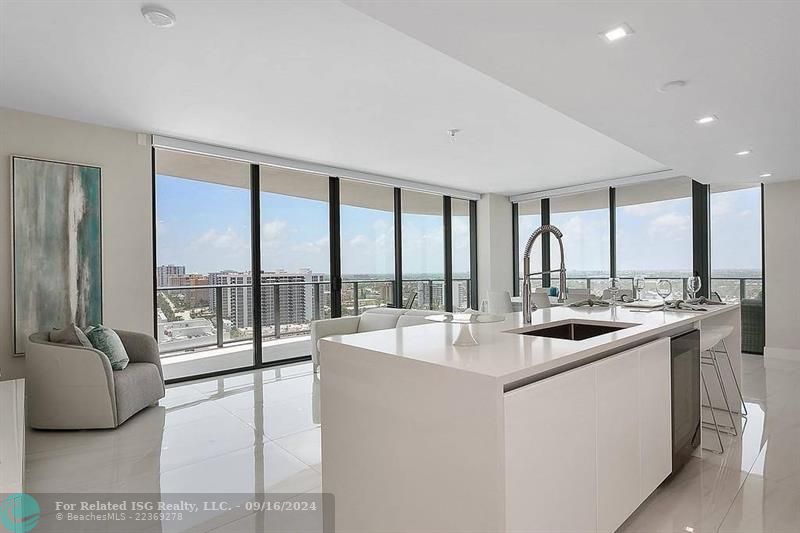 Floor to ceiling windows with panoramic views of ocean & night city skyline