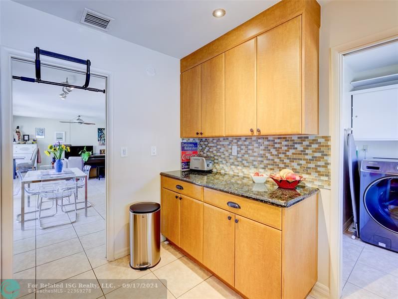 Inside laundry room conveniently located just off the kitchen.