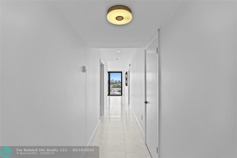 Hallway Leading a Storage Closet on Right, 2nd Bedroom on the Left and Primary on the Right