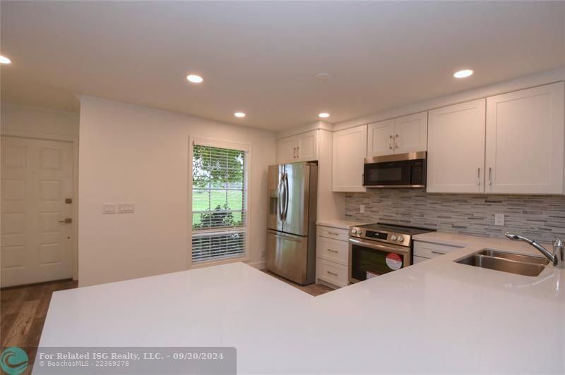 Kitchen looks out to waterfront greenbelt