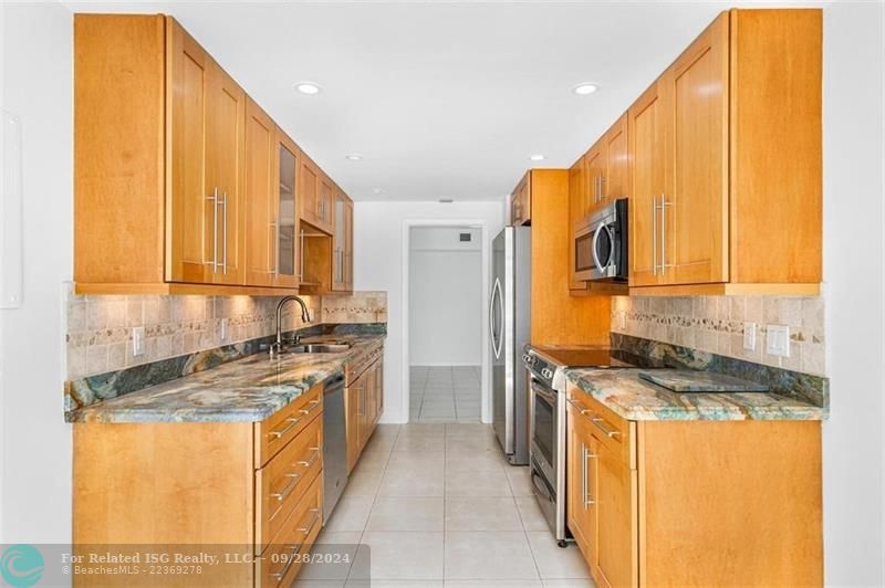 The kitchen has sliding doors that lead out to the balcony.