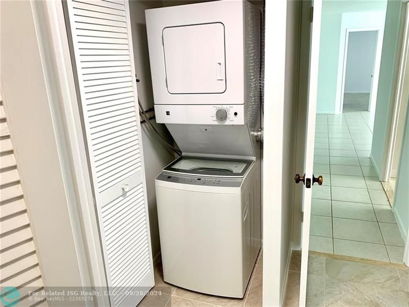 The washer and dryer is in a closet in the second bedroom.