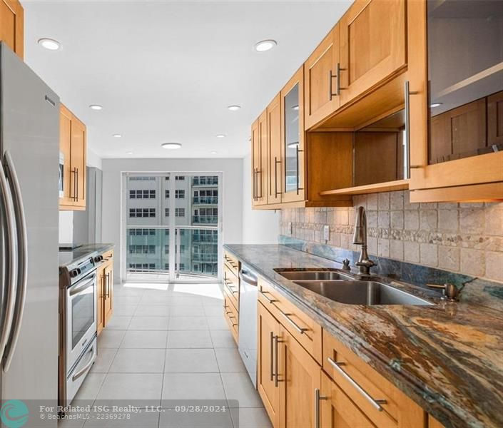 The kitchen has sliding doors that lead out to the balcony.