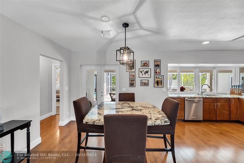 Look how spacious the kitchen area is!  There's the French doors leading to the patio. See that the Primary Suite is tucked away on this side of the home?