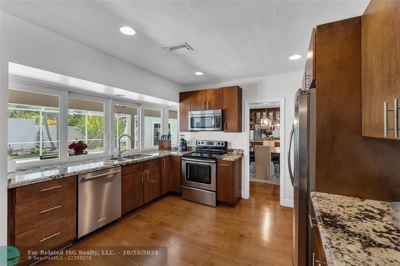 So light!  Notice the formal dining room.....there's a pocket door right there to shield your guests from the secrets of your recipes!  What a GREAT kitchen!