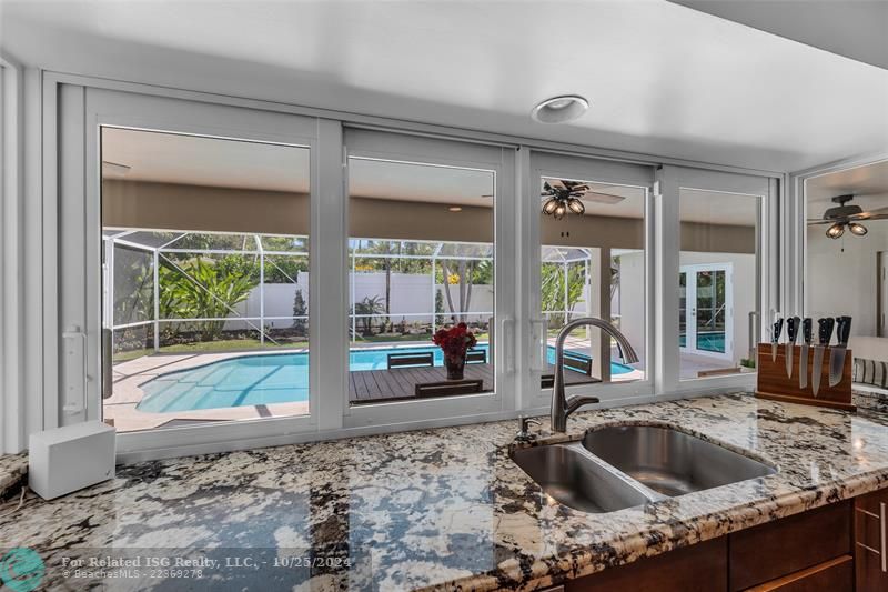 Love the rounded double stainless steel sink, Adore this Granite...but the best?  Opening the sliding Impact windows and joining in with all the FUN!