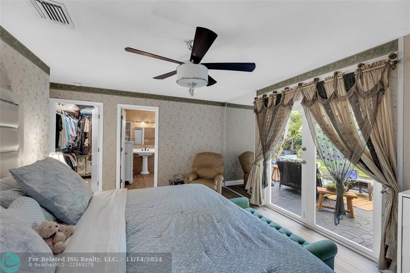 The Main Bedroom opens to the back patio, with a Northern exposure.  The en suite bath is quite spacious.