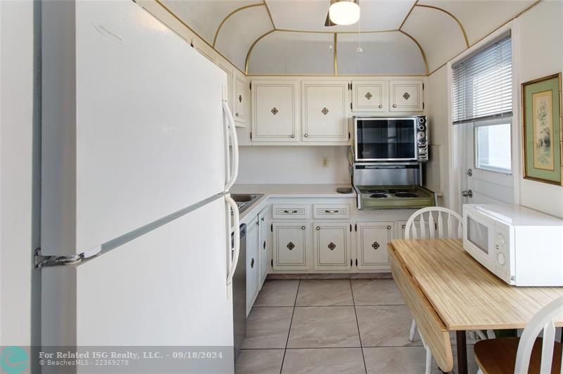 separate entrance impact door into kitchen with a window