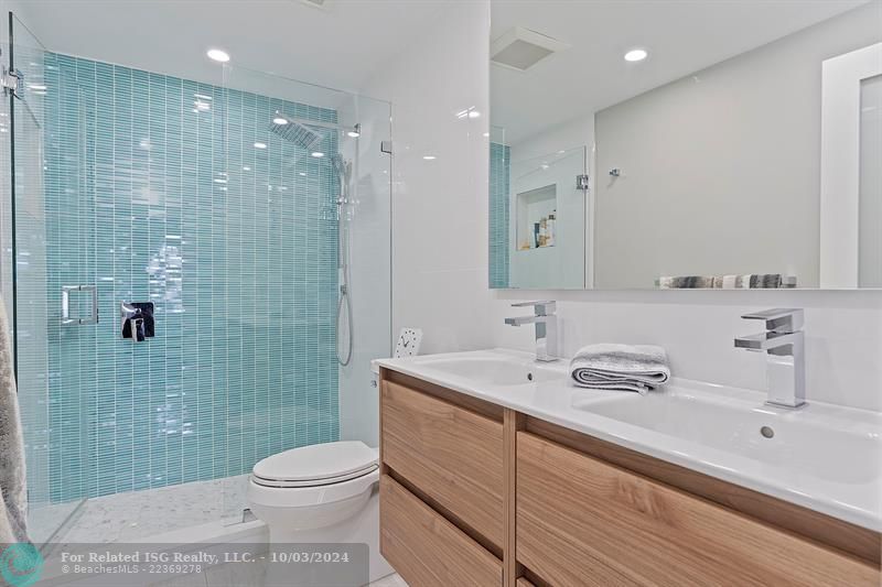 Master Bathroom featuring double sinks and tited shower