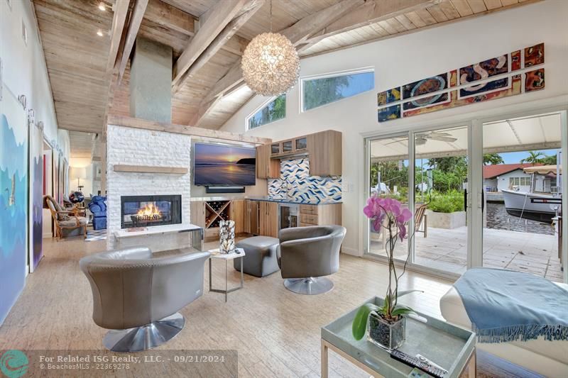 Media room with wet bar and view of the water