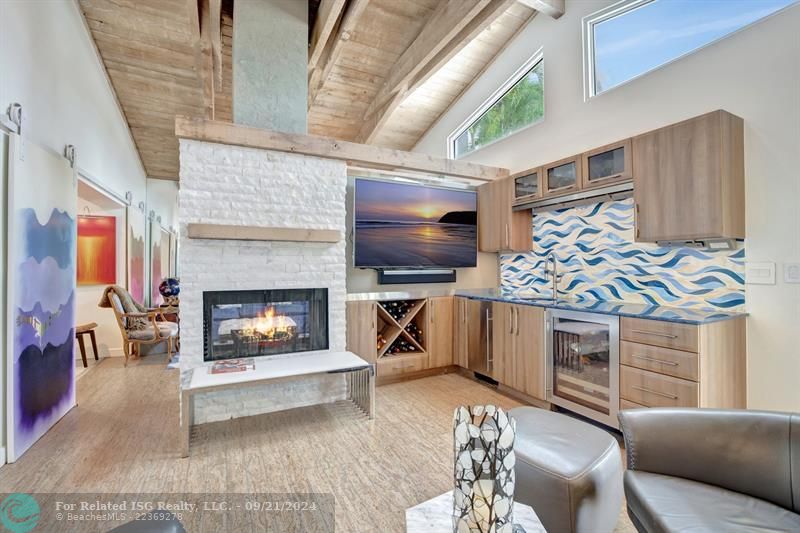 Media room with wet bar and view of the water