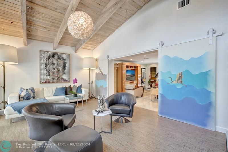 Media room with wet bar and view of the water