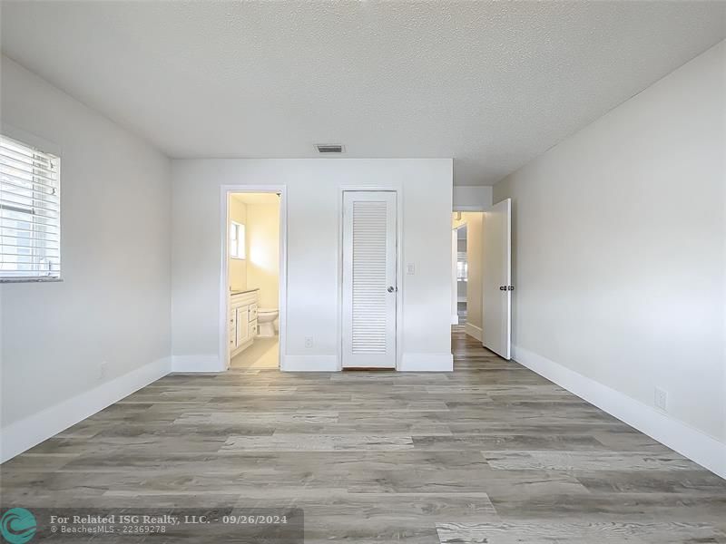 PRIMARY BEDROOM WITH WALK IN CLOSET