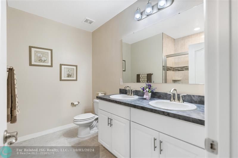 Master bath with dual sink vanity and walk-in shower