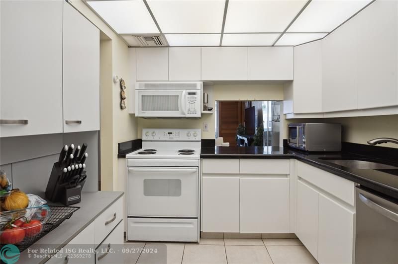 Bright, open kitchen with ample storage and counter space.