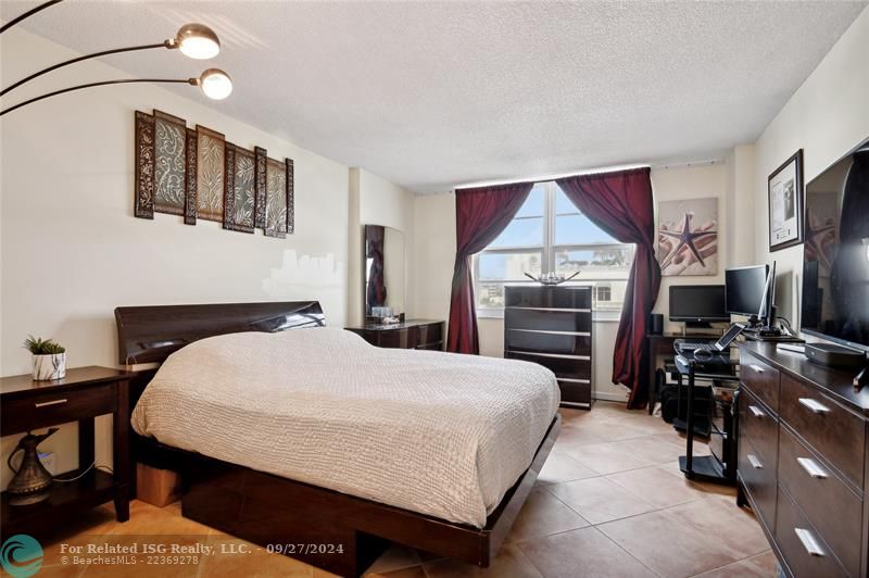 Spacious primary bedroom with private bathroom and walk-in closet.