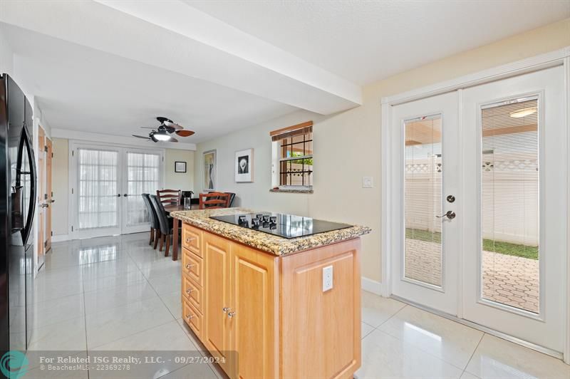 Kitchen to Dining area. Double doors to covered parking. Dining area has double doors to the BONUS ROOM.