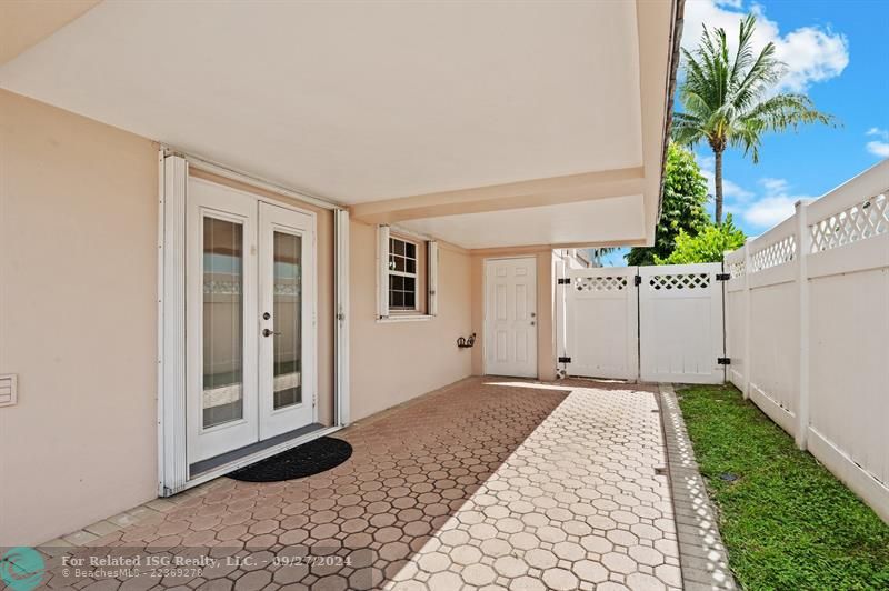 Covered parking with double doors into the kitchen.