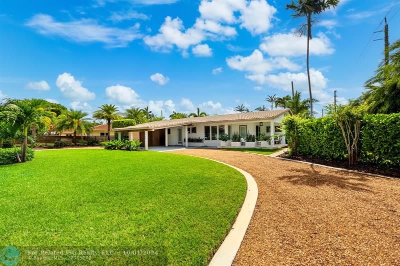 Front of property with meticulous landscaping.