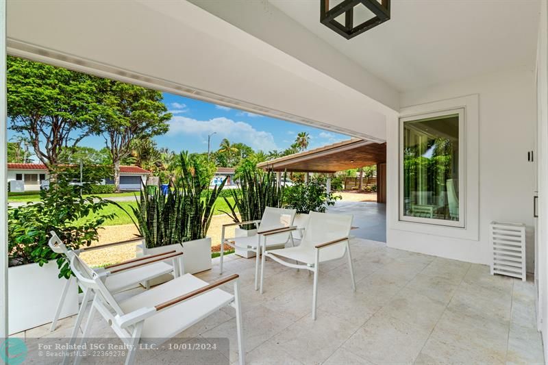 Front covered patio with acces to side yard.