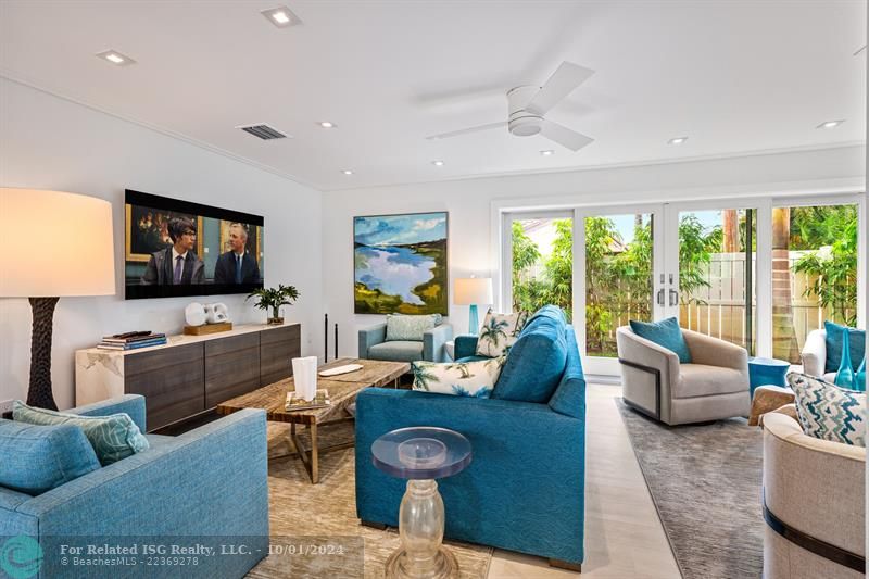 Living room with plenty of seating and access to the yard.